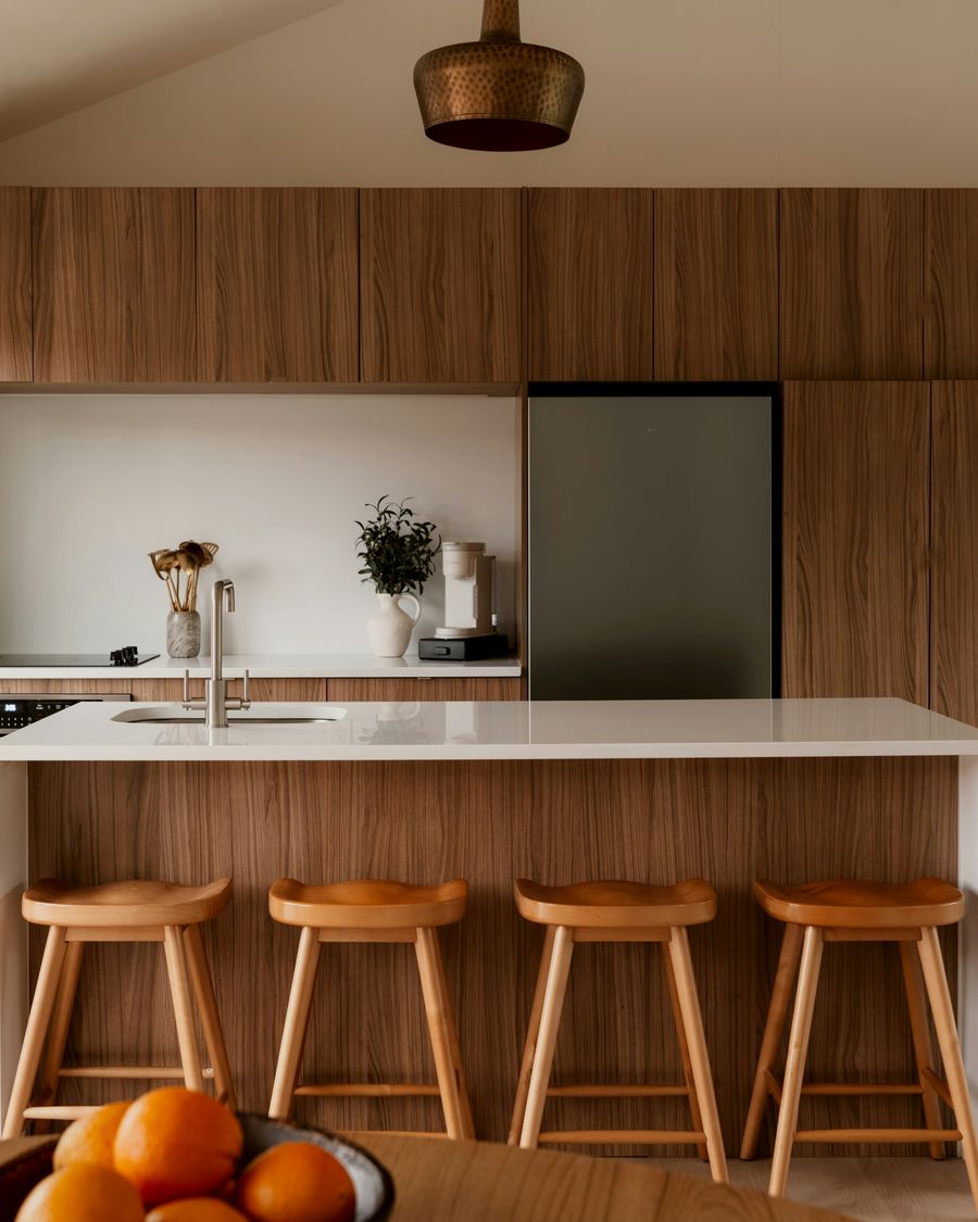 Walnut cabinets around a white island