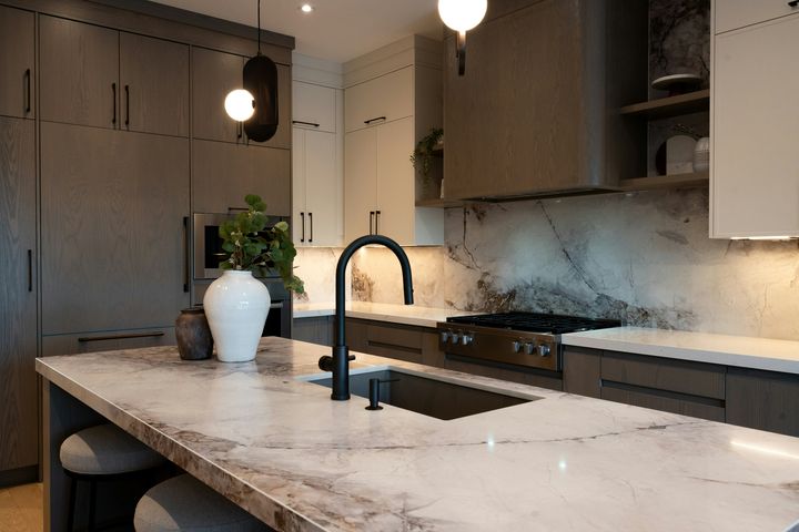 A stone-look island with a dark faucet